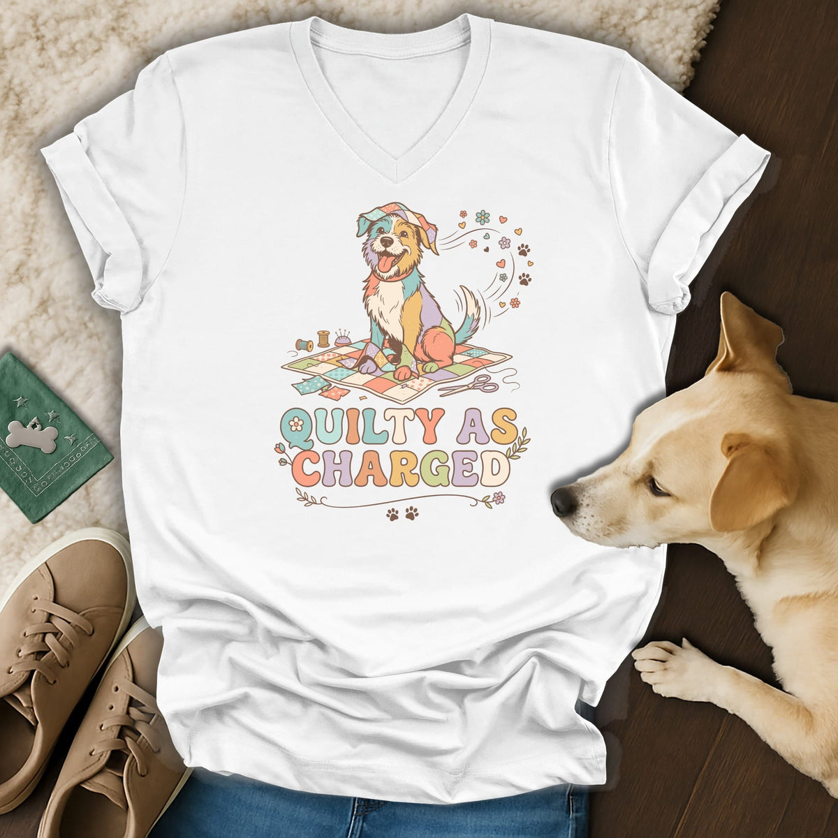 White t-shirt with a colorful dog sitting on a quilt and the text "QUILTY AS CHARGED".