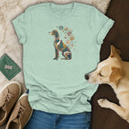 Light green t-shirt featuring a stained-glass dog illustration with flowers, alongside jeans, shoes, and a dog.