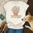 Cream t-shirt with a dog, paw print flowers, and text "HAPPINESS GROWS HERE".