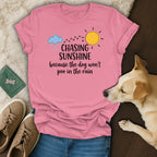 Pink t-shirt with text "Chasing Sunshine Because The Dog Won't Poo In The Rain".