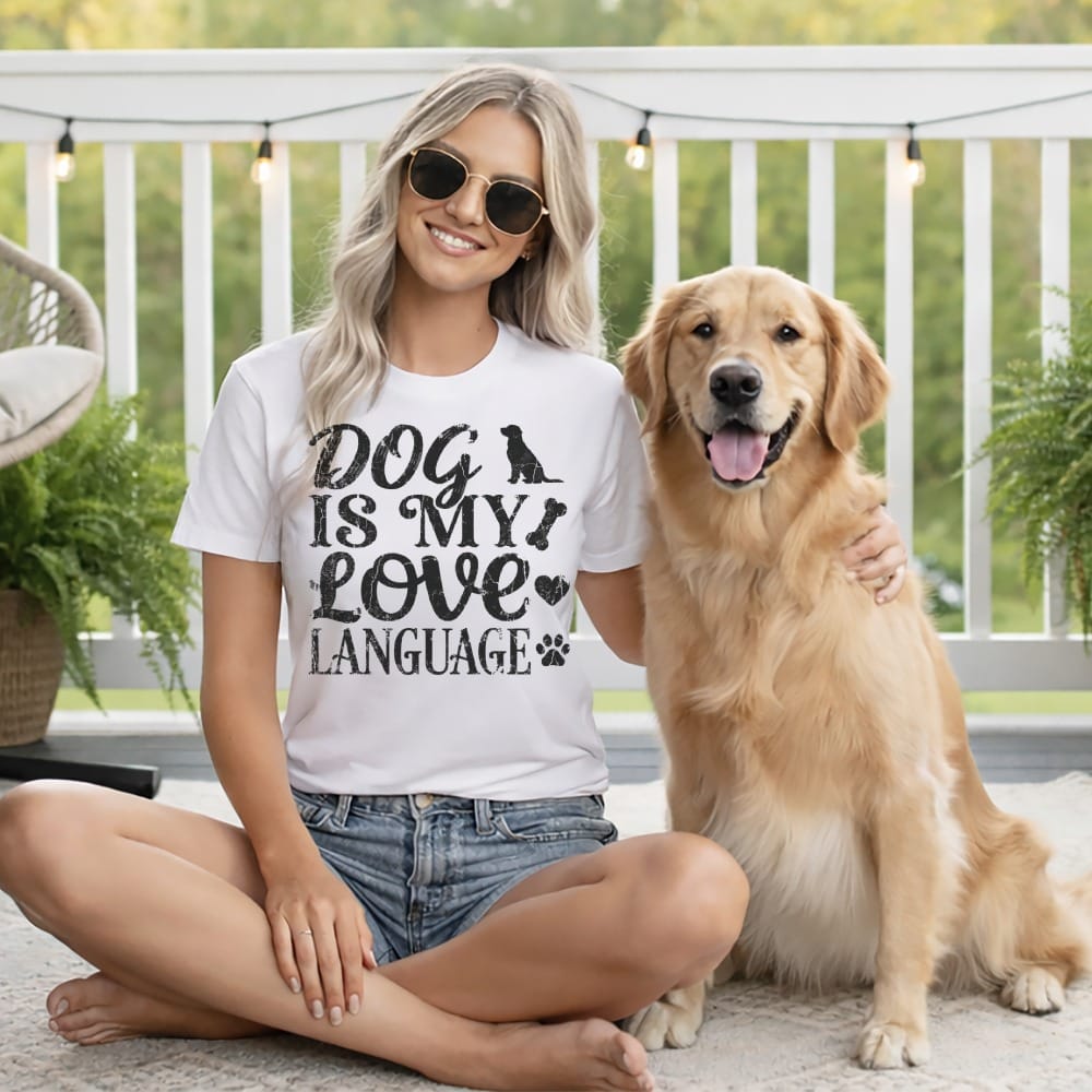 Woman wearing "Dog is my love language" t-shirt with golden retriever.