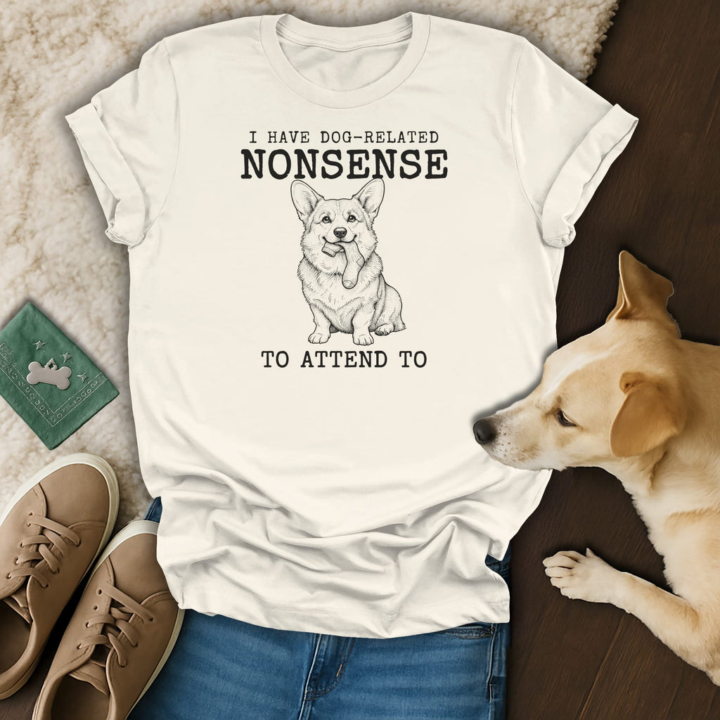 White t-shirt with black text and a drawing of a corgi holding a sock.