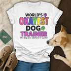 White t-shirt with "World's Okayest Dog Trainer" text.