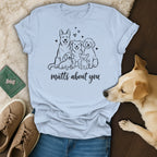 Light blue t-shirt with black line drawing of five dogs and text "mutts about you".