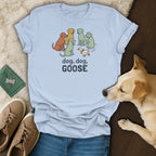 Light blue t-shirt with cartoon dogs and a duck, reads "dog, dog, GOOSE".