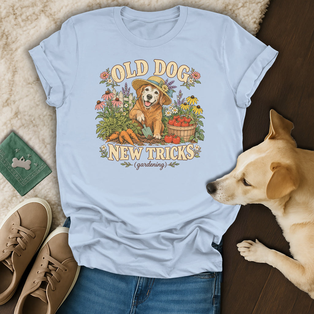 Light blue t-shirt featuring a gardening golden retriever graphic and the text Old Dog New Tricks.