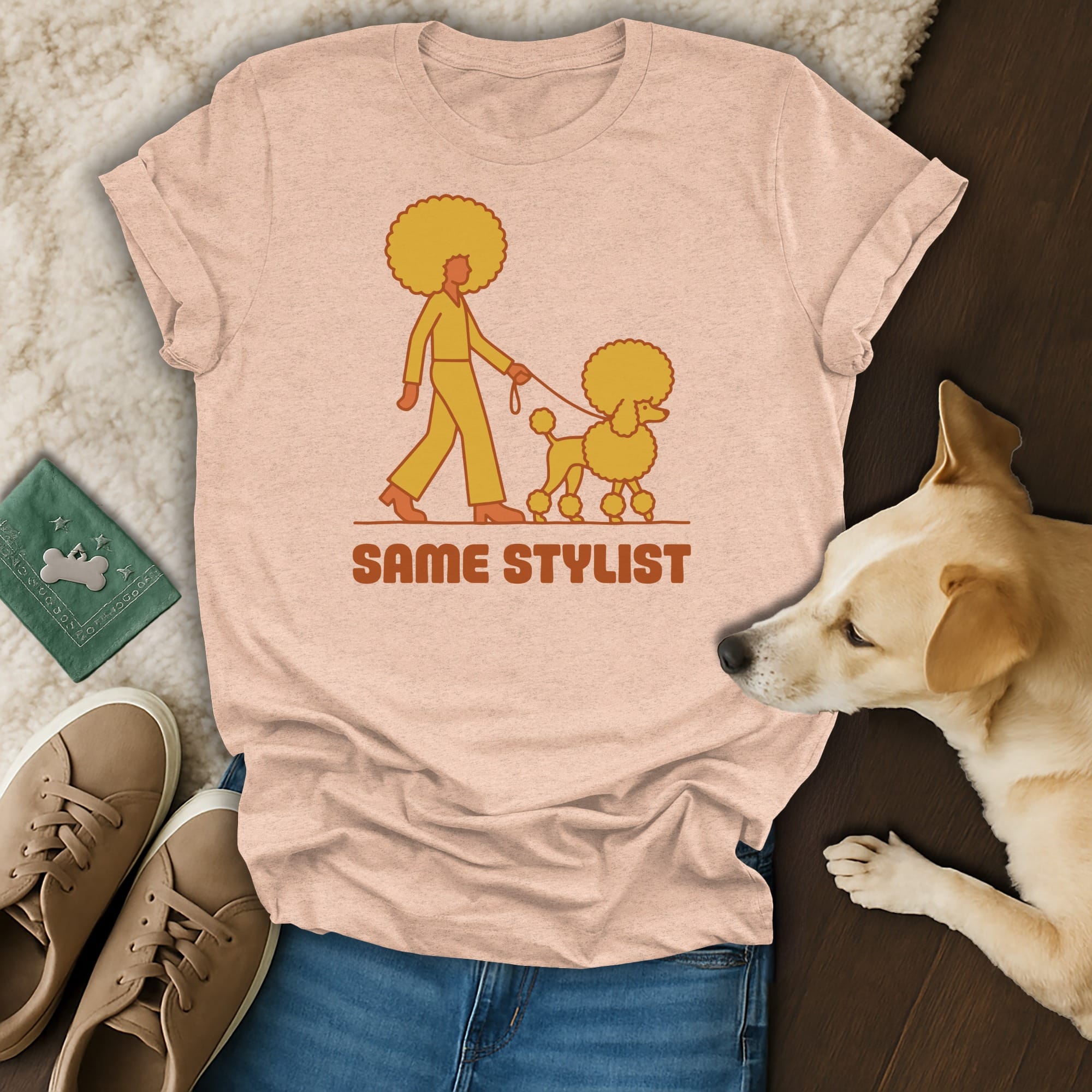 Pink t-shirt with a poodle and person graphic and text "SAME STYLIST".