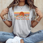 Grey t-shirt with retro sunset and dogs graphic.