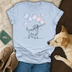 Line art of a dog blowing bubbles on a light blue t-shirt.