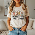 T-shirt with cartoon dogs wearing sweaters and "Mutts About Autumn" text.