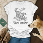 White t-shirt with a dog amidst plants and a bone, text "Rainy Day Fund".