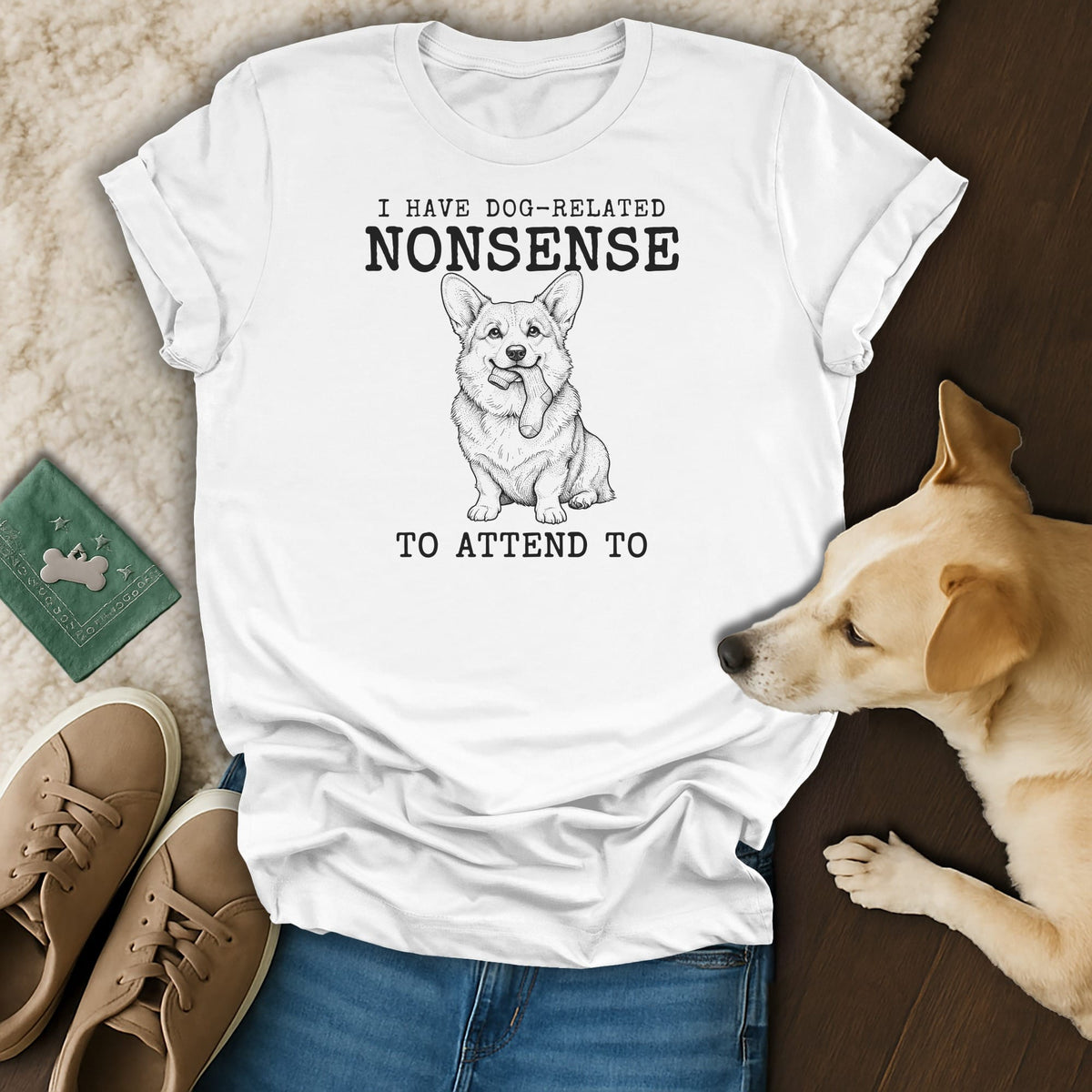White t-shirt with a drawing of a corgi holding a sock and text: "I HAVE DOG-RELATED NONSENSE TO ATTEND TO".