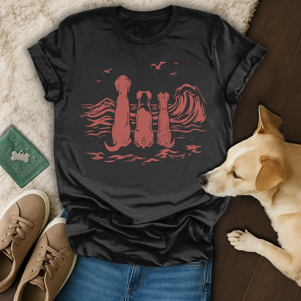 Black t-shirt with three dogs looking at a coral wave illustration.