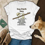 White t-shirt with "Dog Park Day" text and a dog carrying a large stick.