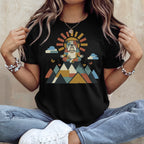 Bulldog meditating in colorful geometric mountains with sun and clouds graphic on black t-shirt.