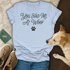 Light blue t-shirt with "You Had Me At Woof" text and paw print.