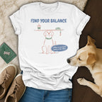 White t-shirt graphic: dog balancing coffee and leash, text "Find Your Balance."