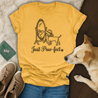 Yellow t-shirt with "Just Paw-fect" text and dog looking in a mirror.