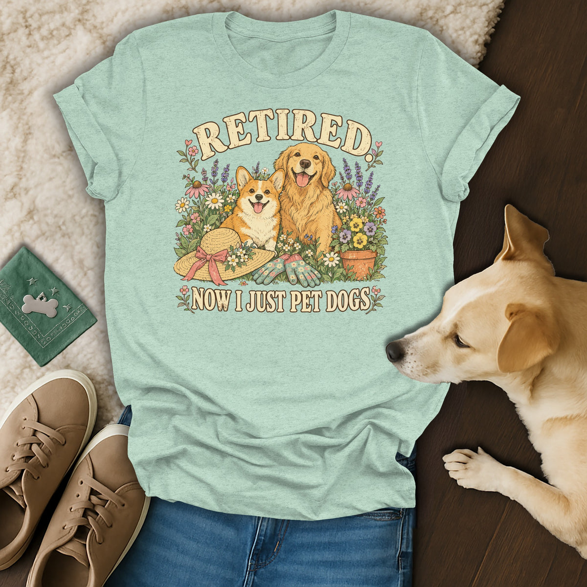 Light green t-shirt with a vintage graphic of dogs, flowers, and the text Retired Now I Just Pet Dogs.