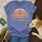 Purple t-shirt with yoga dogs, mandala, and sunset graphic.
