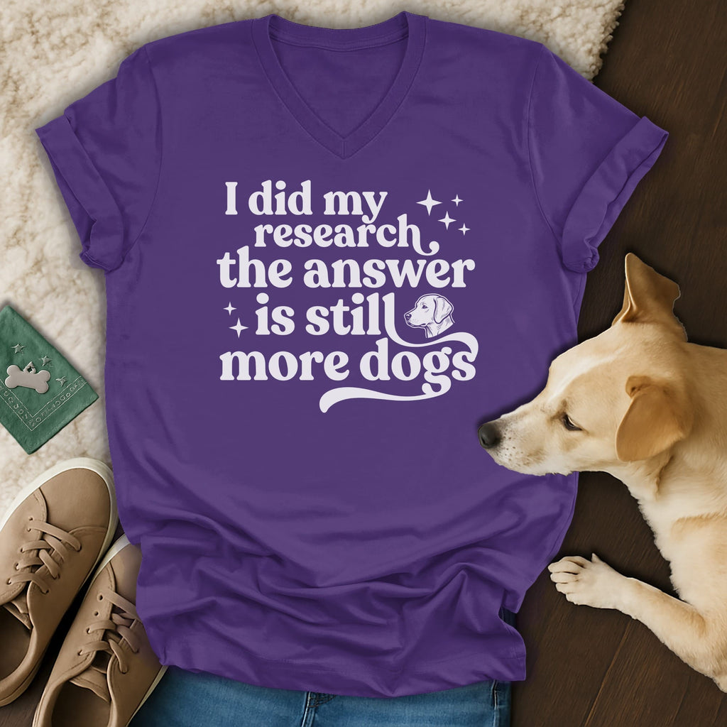 Purple v-neck t-shirt with white text "I did my research, the answer is still more dogs"