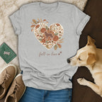 Grey t-shirt with a heart-shaped floral design featuring a dog silhouette and text: "fall in love".