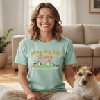 Woman wearing a light blue t-shirt with cartoon dogs and party decorations.