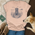 T-shirt with a dog on a surfboard with a lei, next to jeans, shoes, and a dog.
