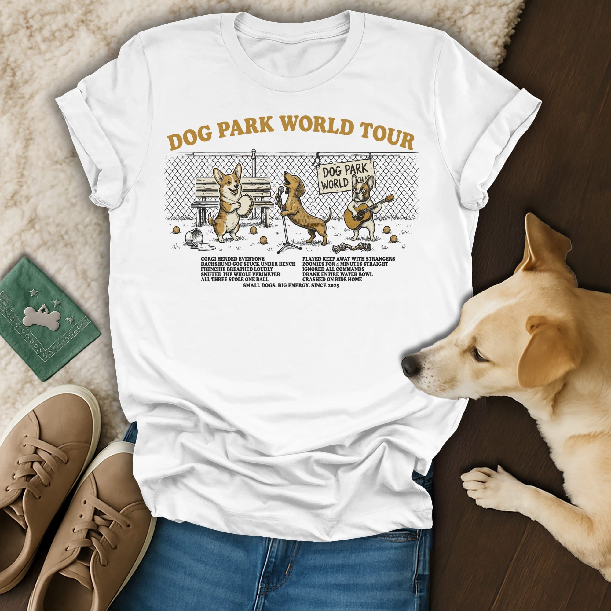 T-shirt with "Dog Park World Tour" graphic featuring cartoon dogs and humorous park activities.