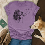 Basset hound blowing dandelion seeds with paw prints.