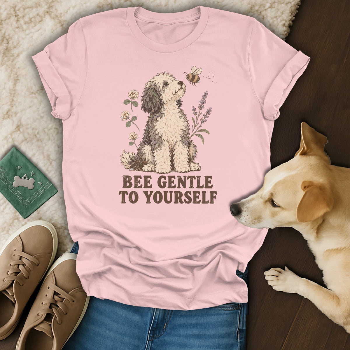 Light pink t-shirt featuring a doodle dog illustration and the text BEE GENTLE TO YOURSELF.