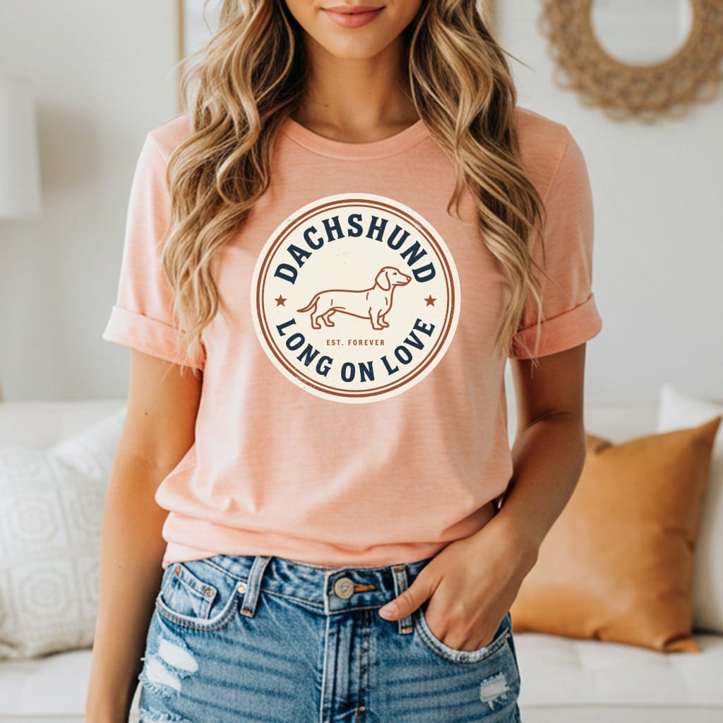 Peach t-shirt with "Dachshund Long On Love Est. Forever" text and dachshund graphic.