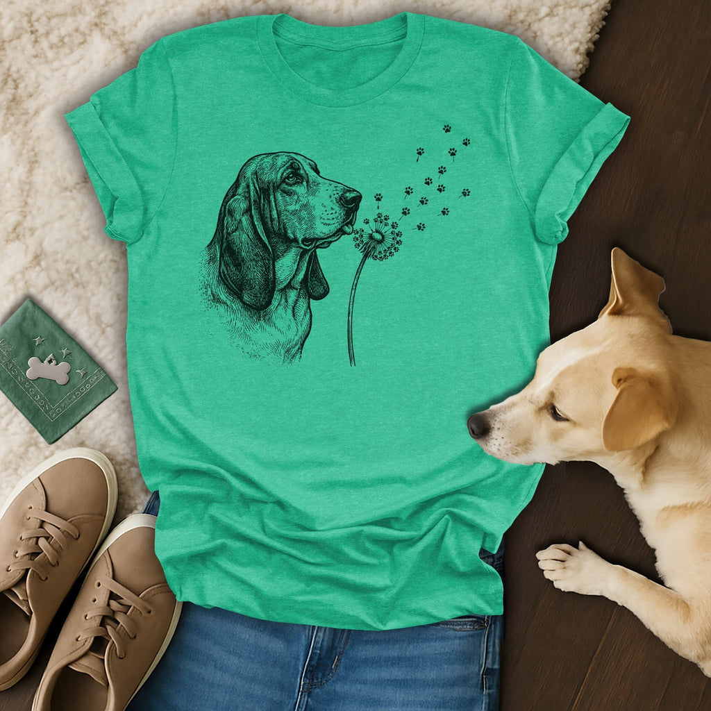 T-shirt with a sketched basset hound blowing dandelions that turn into paw prints.