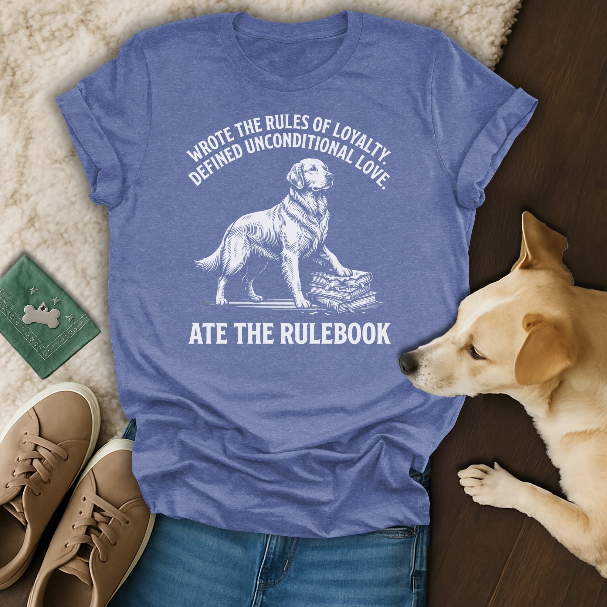 Blue t-shirt with graphic of a golden retriever on books, text about loyalty and rules.