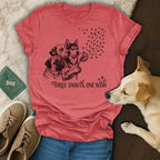 Three dogs holding a dandelion with paw print "seeds" and text "THREE SNOUTS, ONE WISH".