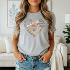 Gray t-shirt with a heart-shaped graphic of dog-related items.