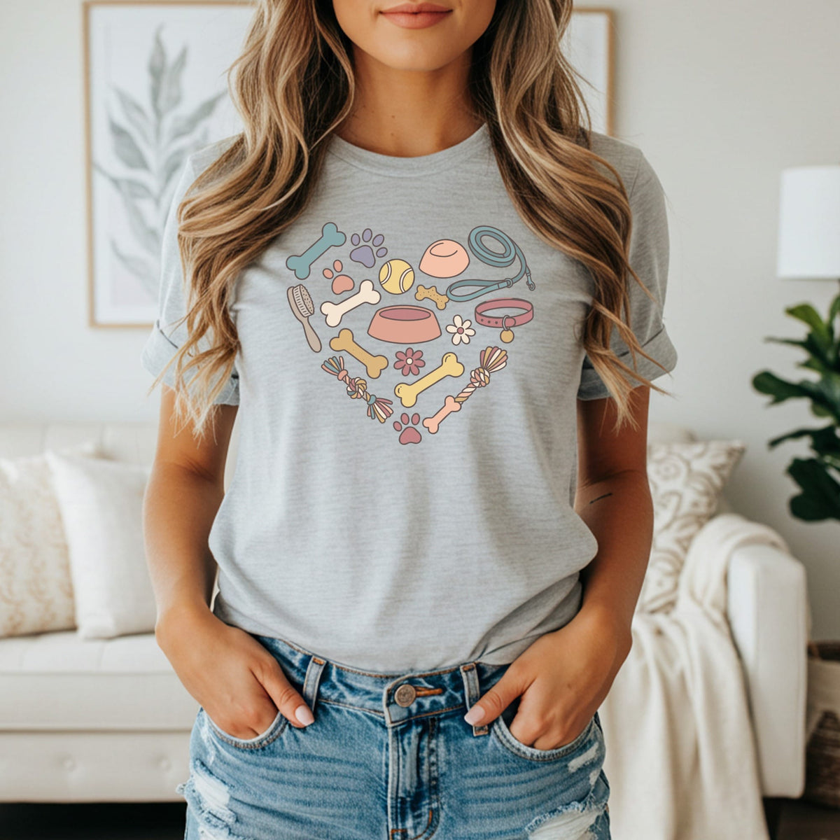 Gray t-shirt with a heart-shaped graphic of dog-related items.