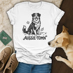 White t-shirt with black line drawing of an Australian Shepherd and "Aussie-Tumn" text.