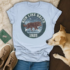 Light blue t-shirt with "Run Like Balto 1925" text and a dog graphic.