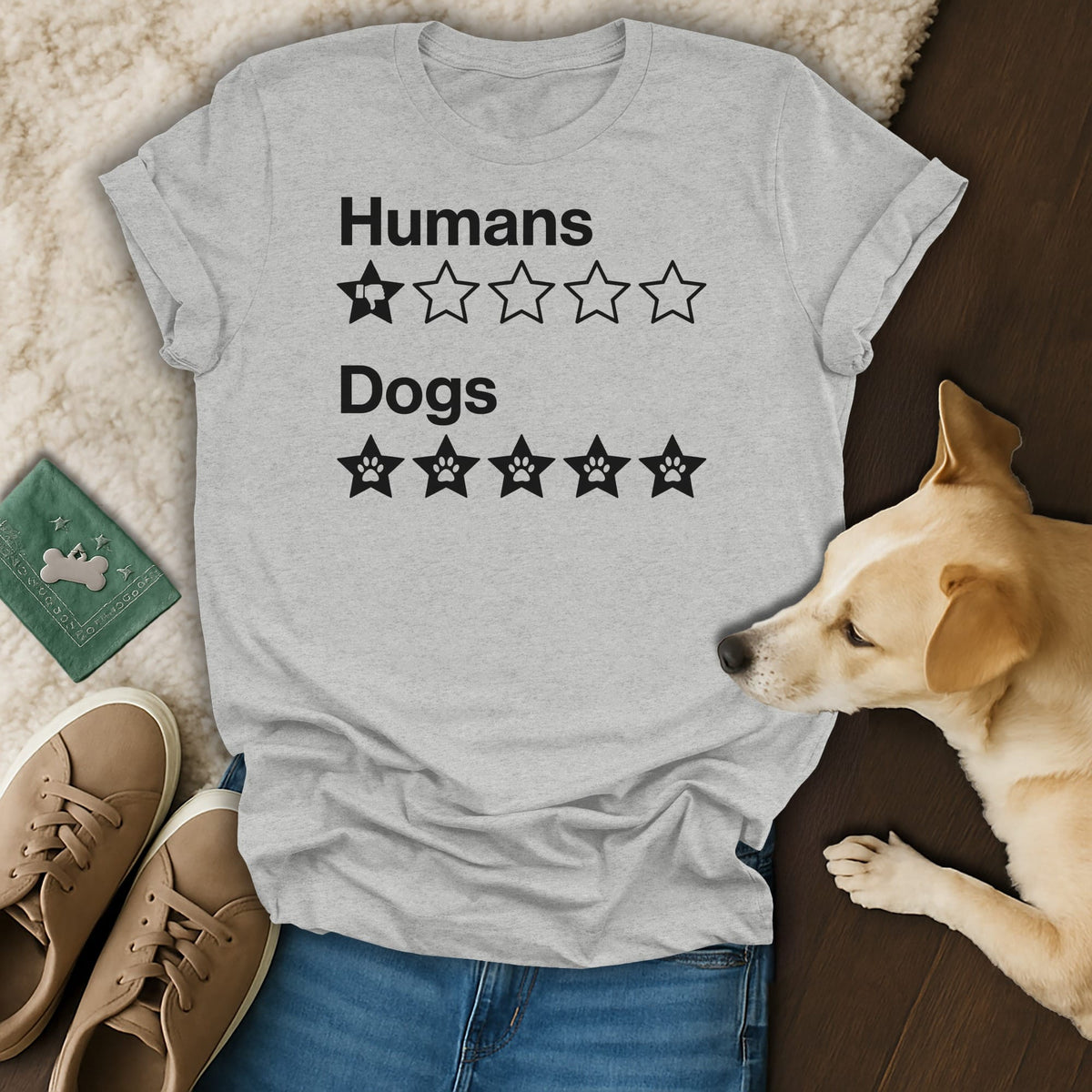 Light grey t-shirt with "Humans" and one star with a thumbs down, and "Dogs" with five paw print stars.