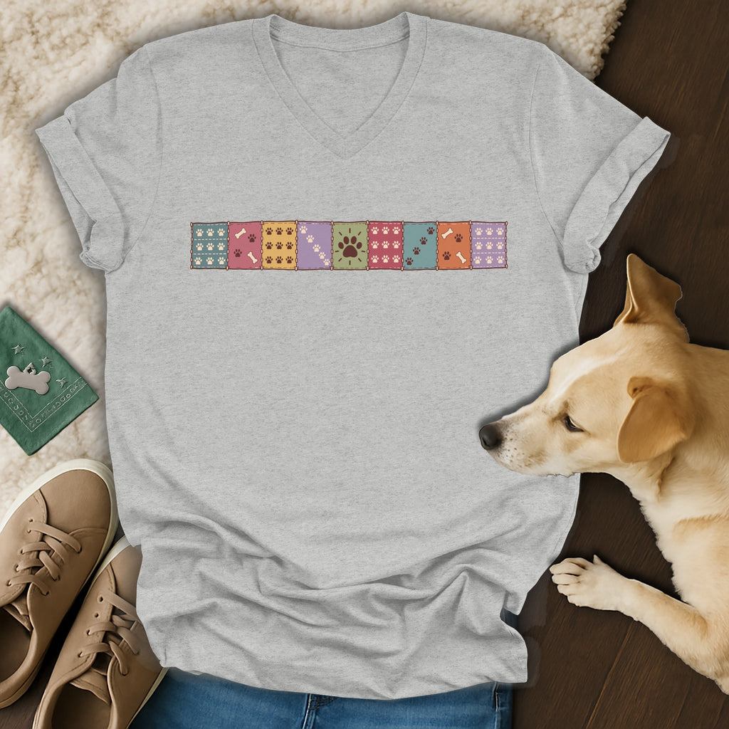 Heather gray V-neck t-shirt featuring a colorful row of patterned paw print squares across the chest.