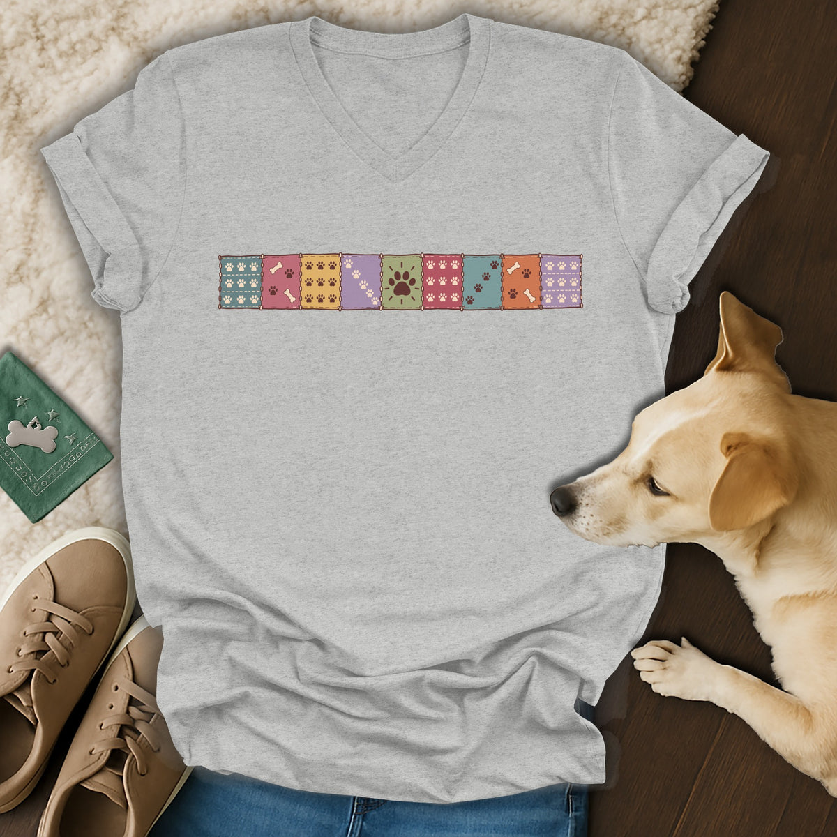 Heather gray V-neck t-shirt featuring a colorful row of patterned paw print squares across the chest.