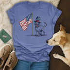 Dog in top hat salutes American flag on blue t-shirt.