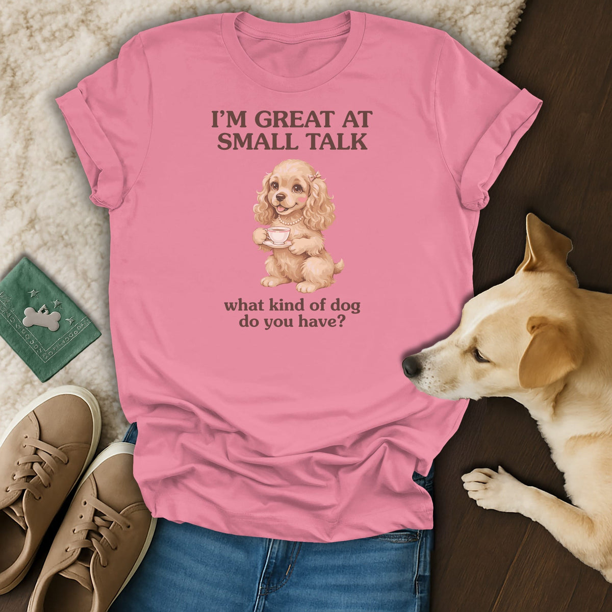 Pink t-shirt with a cocker spaniel holding a teacup and text reading "I'M GREAT AT SMALL TALK".