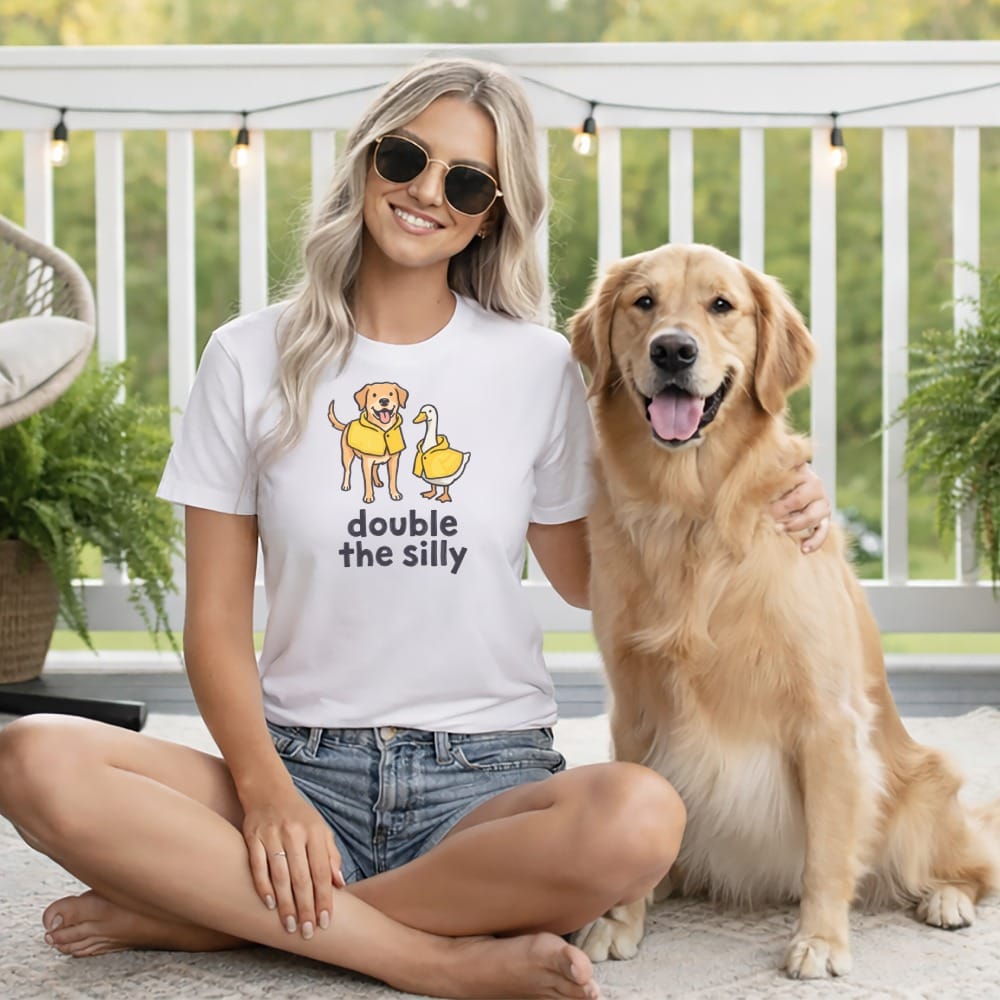 White t-shirt with dog and duck graphic and "double the silly" text.