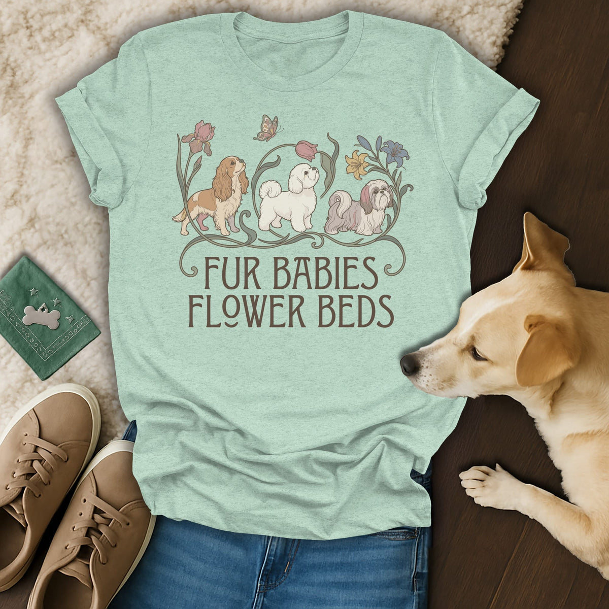 A light green t-shirt with a graphic of three dogs and the text FUR BABIES FLOWER BEDS.
