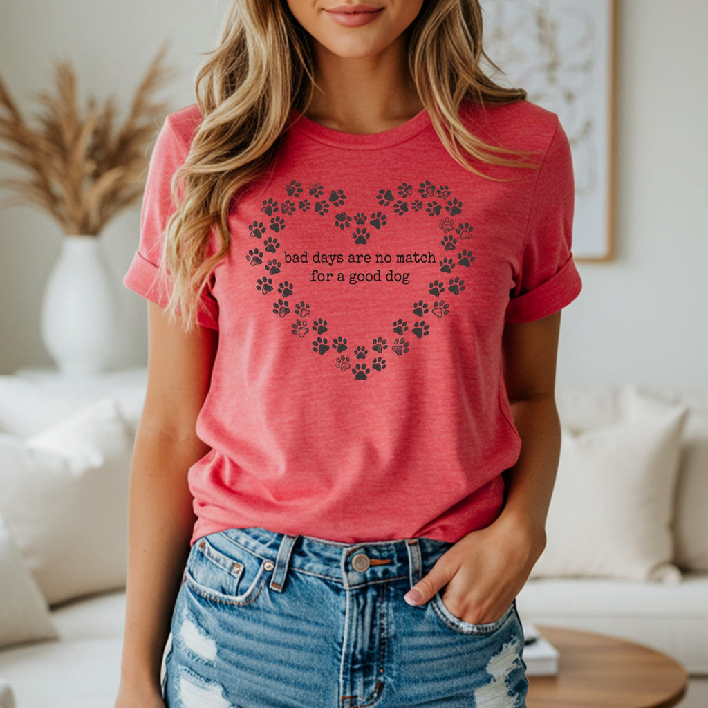 Coral t-shirt with a heart design made of paw prints and text.