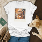 White t-shirt with a graphic of a dog wearing glasses and a scarf holding a coffee.