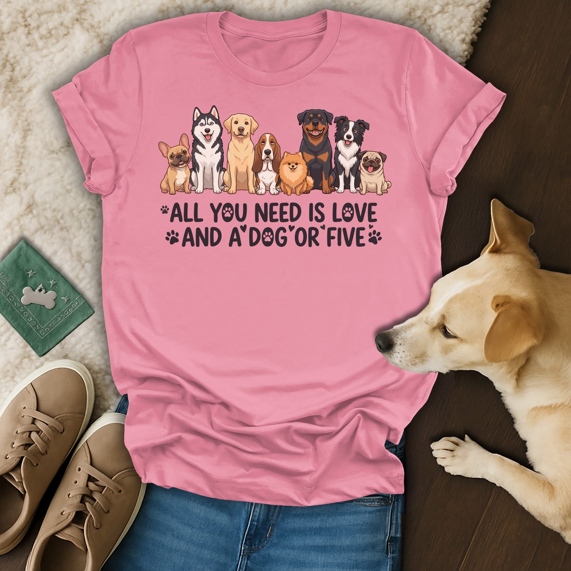 Pink t-shirt with dogs and text "All you need is love and a dog".
