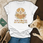 White t-shirt with illustration of dog, sunflowers, paw print, and text "MY DOG IS MY SUNSHINE".